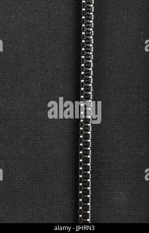 black plastic zipper with black  background and copy space. Stock Photo