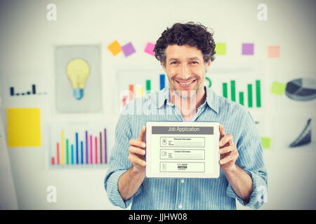 Businessman showing digital tablet with blank screen in creative office against digitally generated image of job application Stock Photo