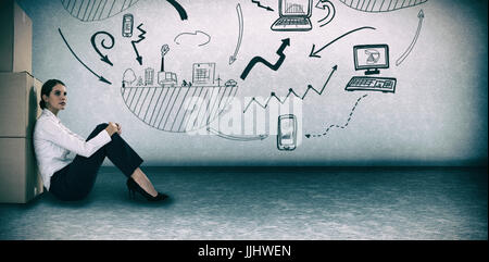 Businesswoman leaning on cardboard boxes against white background against grey room Stock Photo