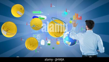Businessman analyzing graphs on blue background by 3d various emojis Stock Photo