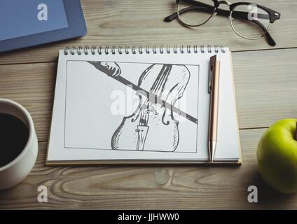 Cello doodle on notepad with coffee and green apple Stock Photo