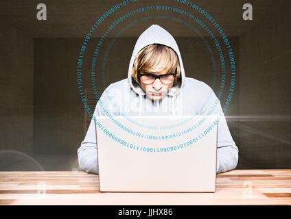 Blond hair hacker using a laptop in a room Stock Photo