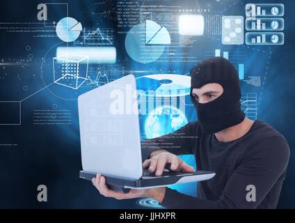 Hacker using a laptop in front of digital background Stock Photo