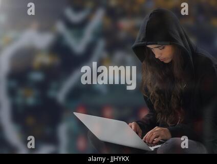 Woman hacker with crossed legs using a laptop Stock Photo