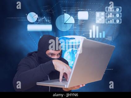 Hacker with hood  working on a laptop in front of blue digital background Stock Photo