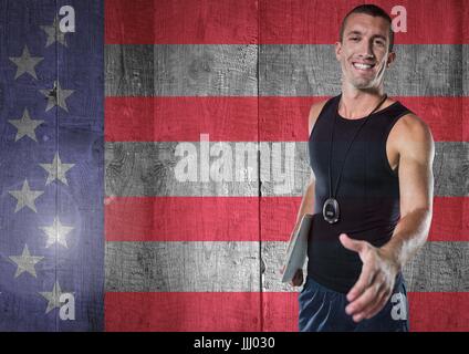 Sports coach shaking his hand against american flag Stock Photo