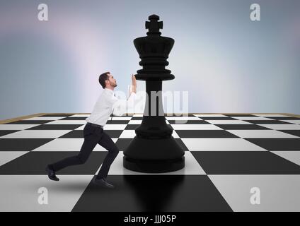 Business man pushing 3D chess piece against purple abstract background Stock Photo