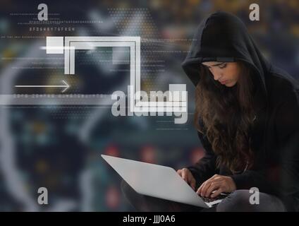 Woman hacker using a laptop in front of digital background Stock Photo