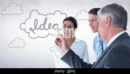 Innovative business team looking at 3D idea graphic against white wall Stock Photo