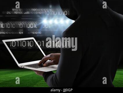 View from the back of hacker using a laptop Stock Photo