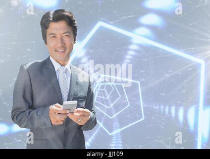Smiling businessman texting against interface Stock Photo