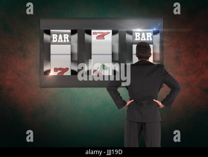 Back of Man Looking at 3d casino slot machine Stock Photo
