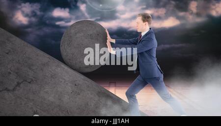 Man pushing 3D rolling round rock Stock Photo