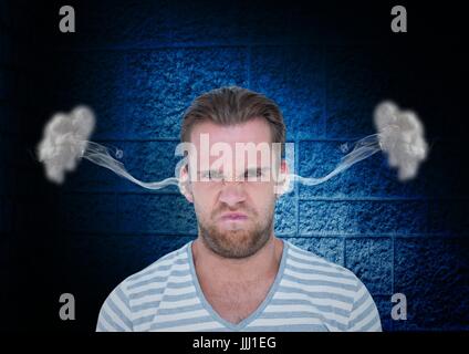 anger young man with steam on ears. Black and blue  background Stock Photo