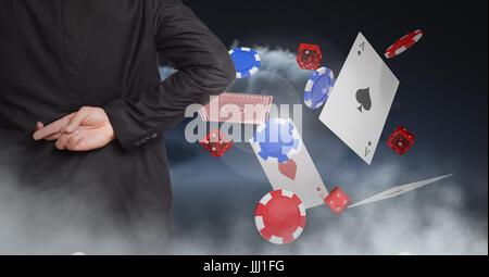 Fingers crossed behind back with poker chips and playing cards Stock Photo
