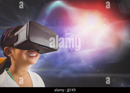 Happy girl in VR headset looking up against black, purple and red galaxy background Stock Photo