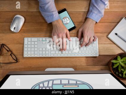 Person using a computer and mobile phone with travel icons on the screen Stock Photo