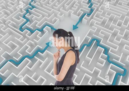 Woman thinking against background with a maze 3d Stock Photo