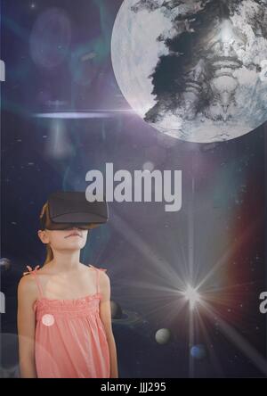 Girl in VR headset looking up to a 3D planet against blue sky with planets and flares Stock Photo