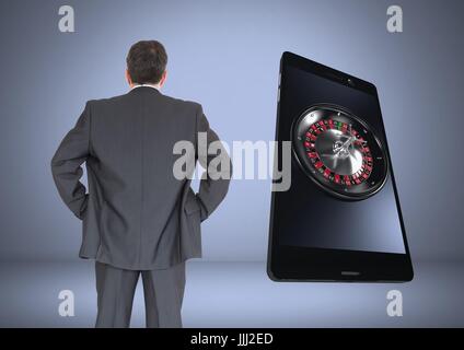 Back of Man Looking at 3d casino roulette on phone Stock Photo