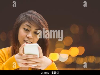 Woman Texting in night city lights bokeh