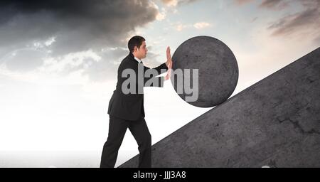 Man pushing 3D rolling round rock Stock Photo