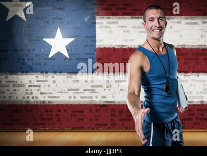 Sports coach shaking his hand against american flag Stock Photo