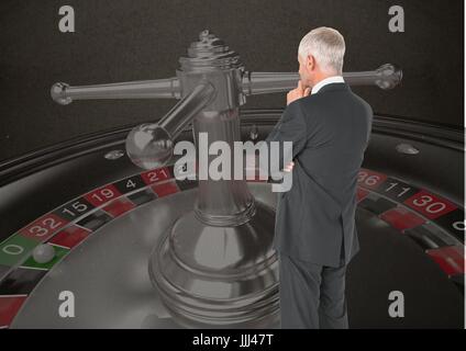 Back of Man Looking at 3d casino roulette Stock Photo