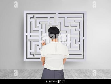 Woman looking to a maze on the wall 3d Stock Photo