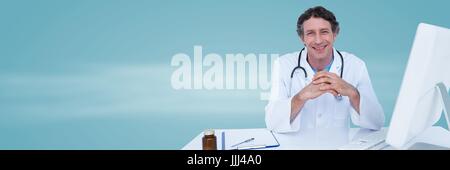 Doctor hands together at desk against blue background Stock Photo