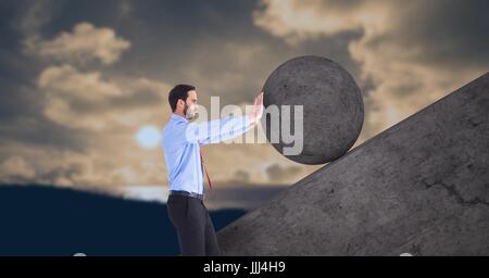 Man pushing 3D rolling round rock Stock Photo