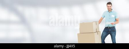 Delivery Courier with boxes in front of blurred background and copy space Stock Photo