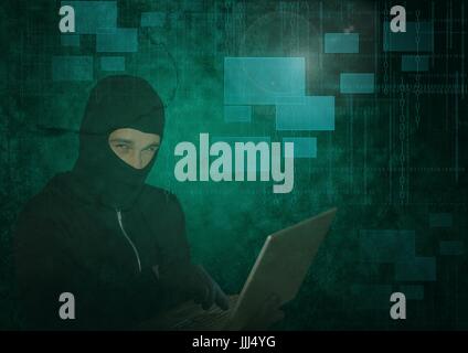 3d Hacker using a laptop in front of green digital background Stock Photo