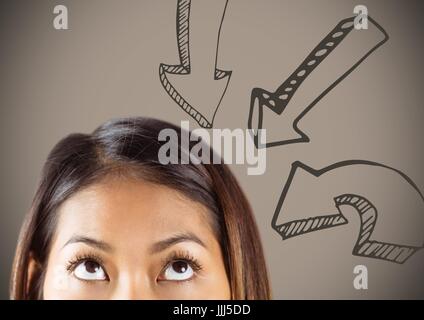 Top of woman's head looking up at downward arrows against brown background Stock Photo