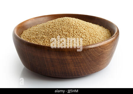 Amaranth seeds in dark wooden bowl isolated on white. Stock Photo