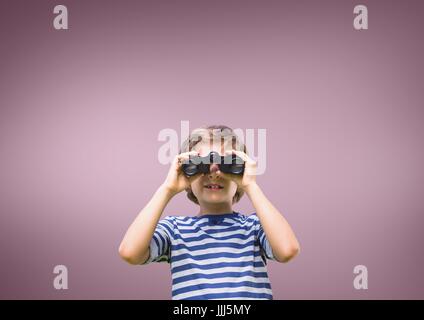 Boy looking through binoculars against pink background Stock Photo
