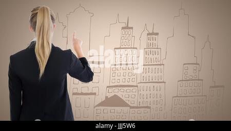 Back of business woman writing city doodle on cream background Stock Photo