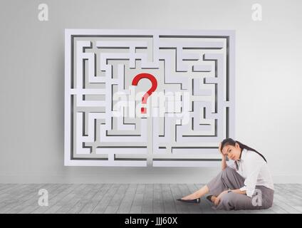 Woman sitting on the floor with a 3d maze behind Stock Photo