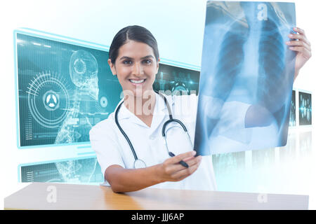 Composite 3d image of female doctor examining chest x-ray Stock Photo