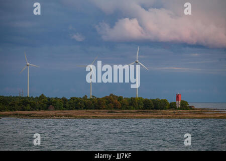 Wind power generators on the coast of Baltic sea. Summer cloudy wheather. Stock Photo