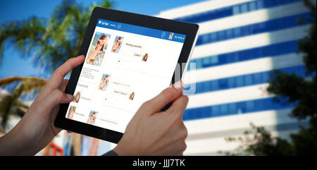 Composite 3d image of cropped image of businesswoman holding digital tablet Stock Photo