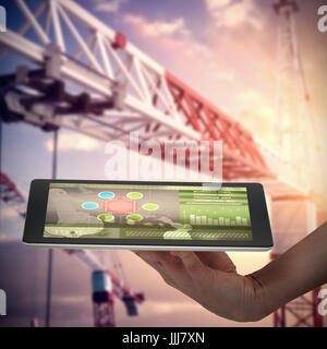 Composite 3d image of human hand holding digital tablet against white background Stock Photo