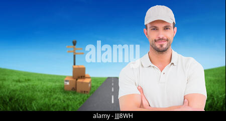 Composite image of delivery man standing arms crossed Stock Photo