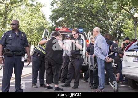 Washington, District Of Columbia, USA. 19th July, 2017. United States Capitol Police officers search protesters who were arrested inside the Russell Senate Office Building on Capitol Hill. The protesters were arrested for demonstrating against senate Republican efforts to repeal and replace the affordable care act. Credit: Alex Edelman/ZUMA Wire/Alamy Live News Stock Photo