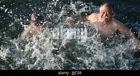 Hefei, China's Anhui Province. 20th July, 2017. People swim in a pool at the Huancheng Park in Hefei, capital of east China's Anhui Province, July 20, 2017. Credit: Yang Xiaoyuan/Xinhua/Alamy Live News Stock Photo