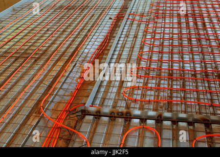 New floor heating system Pipes and heating system at house construction site. floor heating system, the collector and tools Stock Photo