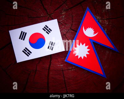 South Korean flag with Nepali flag on a tree stump isolated Stock Photo