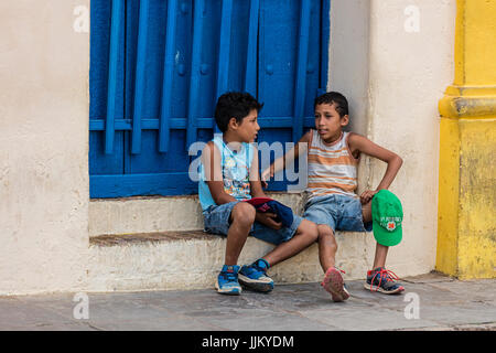 Young boys hand out in the PLAZA MAYOR - TRINIDAD, CUBA Stock Photo