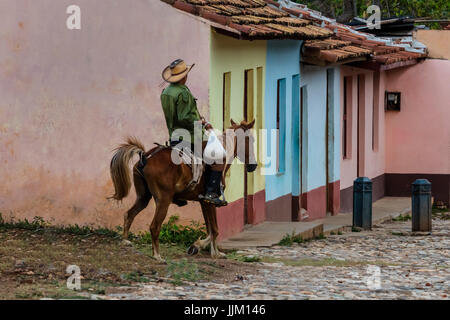 Horses and cowboys are a common site on the cobblestone streets of TRINIDAD, CUBA Stock Photo