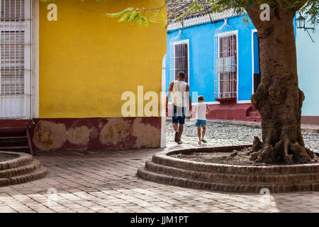 A father and son walking on gthe cobble stone streets - TRINIDAD, CUBA Stock Photo